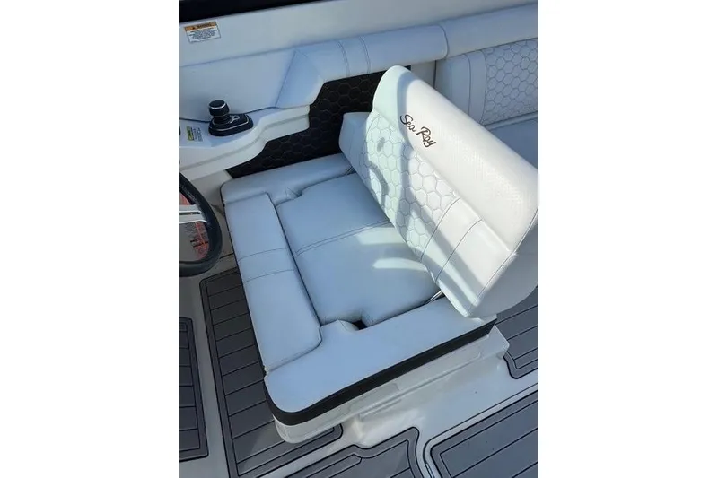 Slide: The Image of 2019 Sea Ray SDX 290 Outboard boat seat with white upholstery and cup holder. - 22