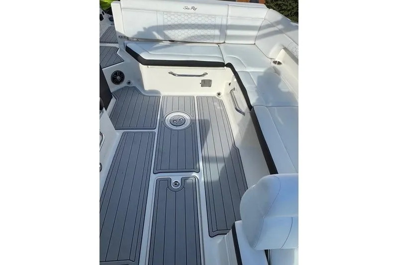 Slide: The Image of 2019 Sea Ray SDX 290 Outboard boat interior with white seating and gray flooring. - 23