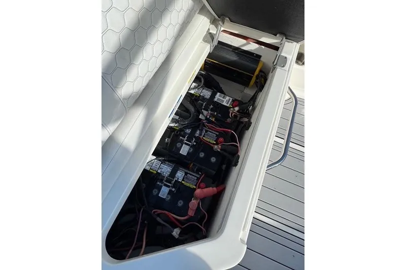 Slide: The Image of 2019 Sea Ray SDX 290 Outboard battery compartment with wiring and components. - 27
