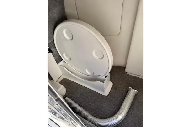 Slide: The Image of 2019 Sea Ray SDX 290 Outboard interior with a folded table and hose. - 29