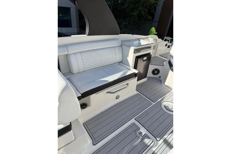 Slide: The Image of 2019 Sea Ray SDX 290 Outboard interior with white seating and sleek flooring. - 33