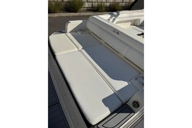 Slide: The Image of 2019 Sea Ray SDX 290 Outboard boat with white cushioned seating area. - 4