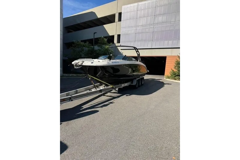 Slide: The Image of 2019 Sea Ray SDX 290 Outboard boat on trailer, parked outdoors. - 6
