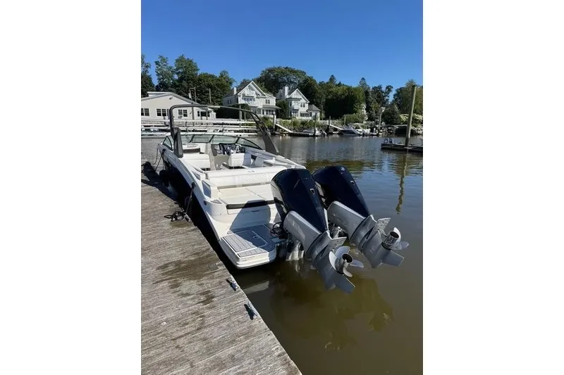 Slide: The Image of 2019 Sea Ray SDX 290 Outboard docked at a marina, featuring dual engines. - 7