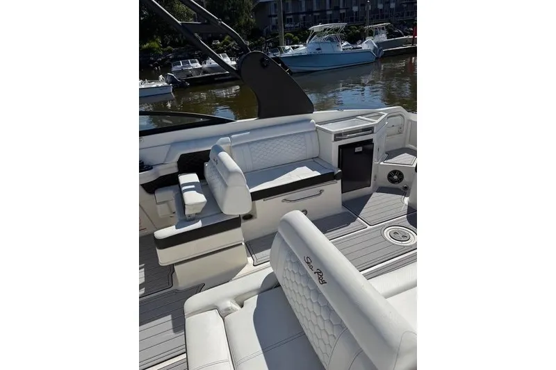 Slide: The Image of 2019 Sea Ray SDX 290 Outboard boat interior with white seating and modern design. - 8