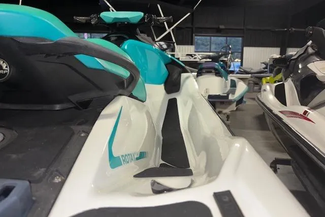 Slide: The Image of 2021 Sea-Doo GTX jet ski in showroom, featuring sleek design and turquoise accents. - 10