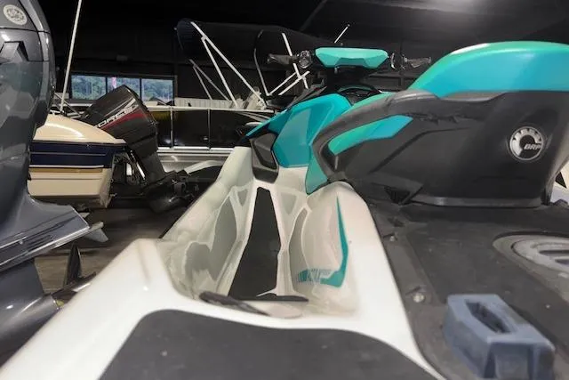 Slide: The Image of 2021 Sea-Doo GTX jet ski in a storage facility, featuring a sleek turquoise and white design. - 11