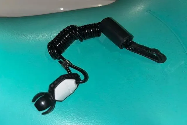 Slide: The Image of Black coiled safety lanyard on a turquoise Sea-Doo GTX 2021 seat. - 14