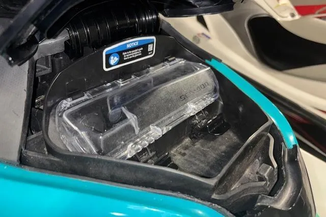 Slide: The Image of 2021 Sea-Doo GTX storage compartment with clear cover and notice label. - 16