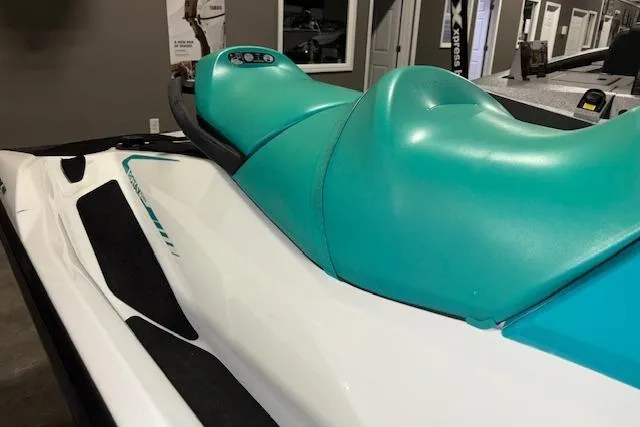 Slide: The Image of 2021 Sea-Doo GTX jet ski with turquoise seat, displayed indoors. - 5