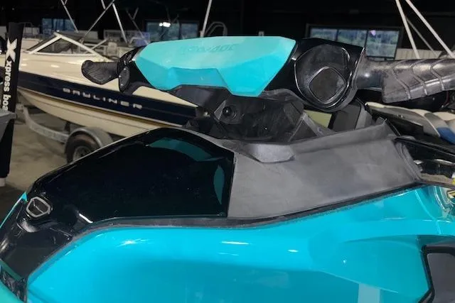 Slide: The Image of 2021 Sea-Doo GTX jet ski handlebars in a showroom with boats in the background. - 6