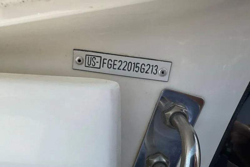 Slide: The Image of Hull identification number on a 2013 Cobalt 220 boat, featuring a metal plate. - 10