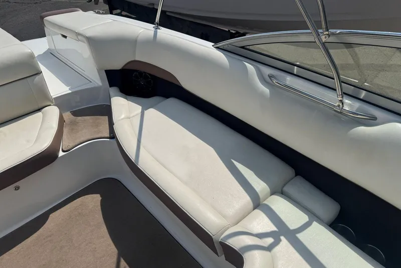 Slide: The Image of Interior of a 2013 Cobalt 220 boat with white and brown seating. - 16