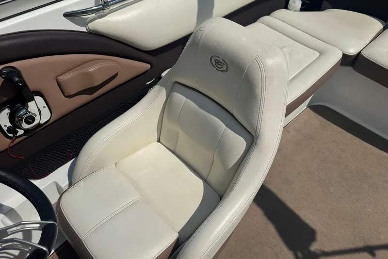 Slide: The Image of 2013 Cobalt 220 boat interior with white leather seating and control panel. - 18