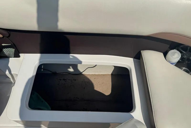 Slide: The Image of Open storage compartment in a 2013 Cobalt 220 boat interior. - 24