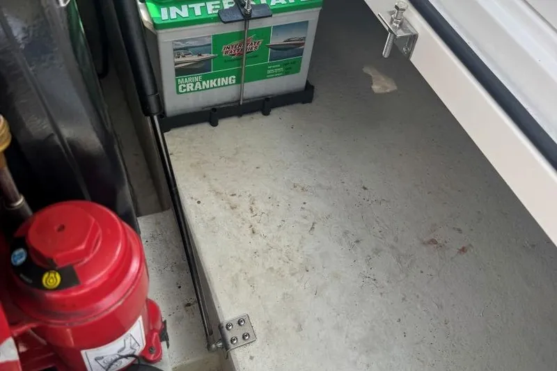 Slide: The Image of Boat battery compartment with marine cranking battery and fire extinguisher, Cobalt 220, 2013 model. - 27