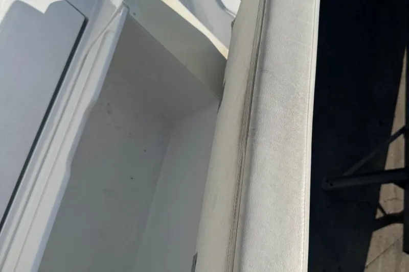 Slide: The Image of Interior view of a 2013 Cobalt 220 boat showing seating and storage compartment. - 28