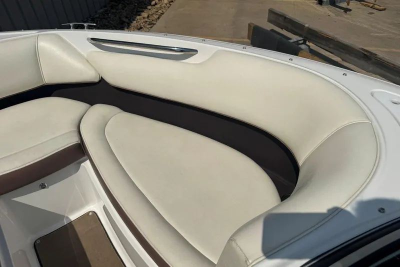 Slide: The Image of 2013 Cobalt 220 boat interior with white cushioned seating. - 30