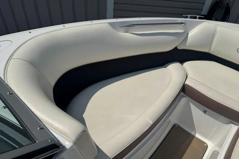 Slide: The Image of 2013 Cobalt 220 boat interior with white cushioned seating. - 31