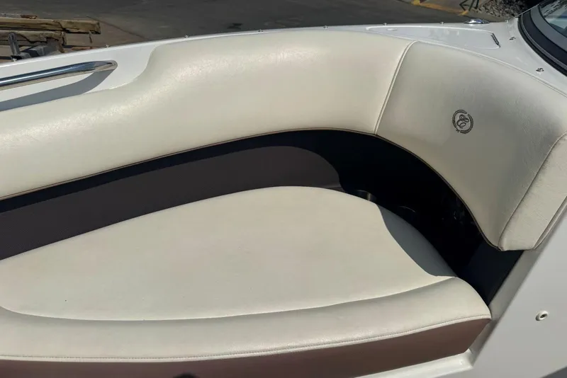 Slide: The Image of 2013 Cobalt 220 boat interior with white cushioned seating. - 32