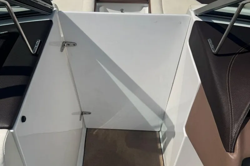 Slide: The Image of Interior view of a 2013 Cobalt 220 boat, featuring sleek seating and a white panel. - 34