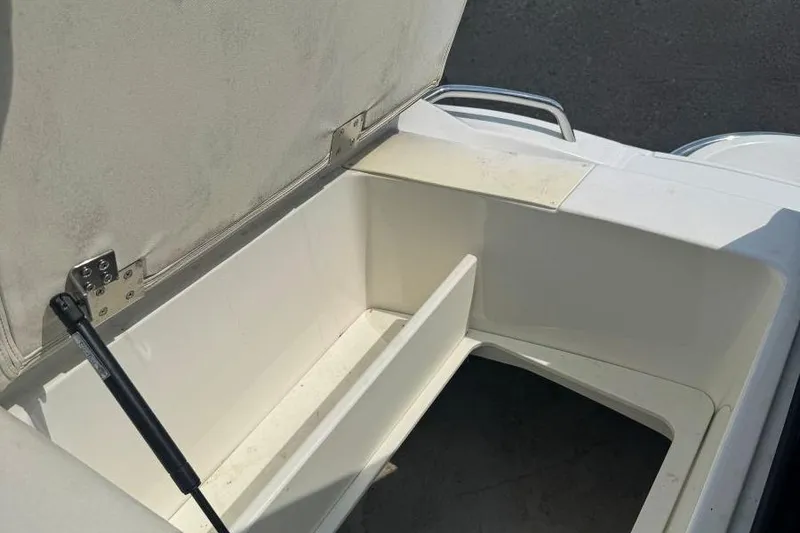 Slide: The Image of Open storage compartment in a 2013 Cobalt 220 boat, showing interior details. - 37
