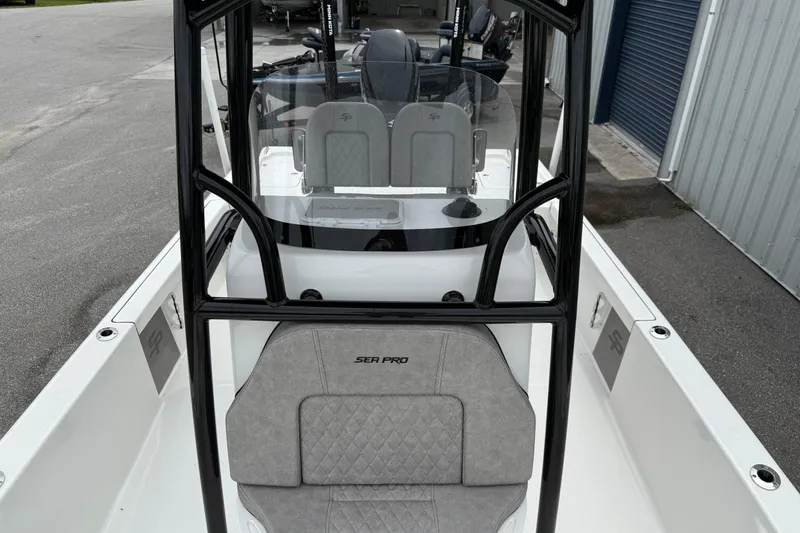 Slide: The Image of 2023 Sea Pro 248 Bay boat interior with seating and console view. - 10
