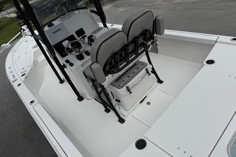 Slide: The Image of 2023 Sea Pro 248 Bay boat interior with helm and seating area. - 11
