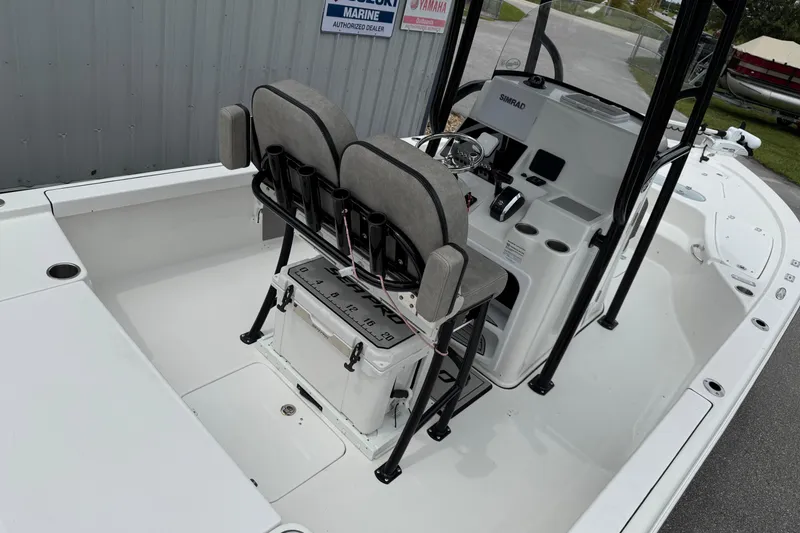 Slide: The Image of 2023 Sea Pro 248 Bay boat interior with helm and seating area. - 12