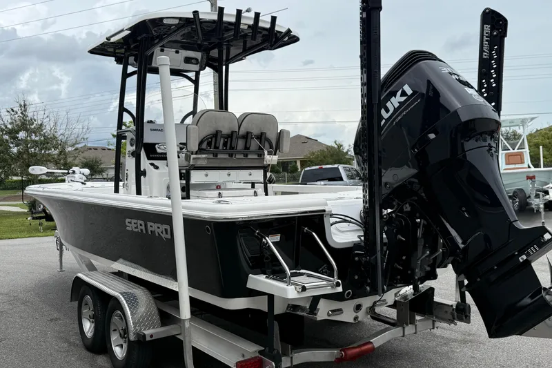 Slide: The Image of 2023 Sea Pro 248 Bay boat on trailer with Suzuki outboard motor. - 23