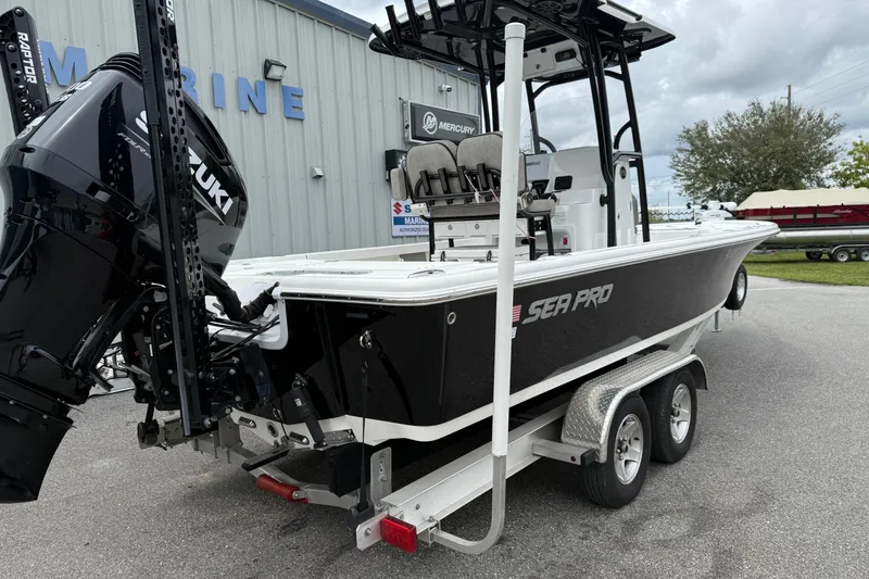 Slide: The Image of 2023 Sea Pro 248 Bay boat on trailer, featuring Suzuki outboard motor. - 25