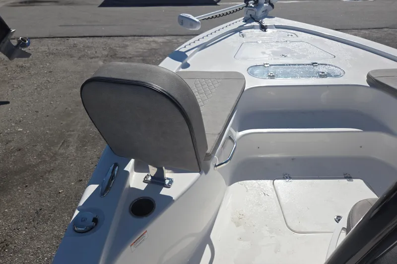 Slide: The Image of 2023 Sea Pro 248 Bay boat interior with seating and storage compartments. - 29