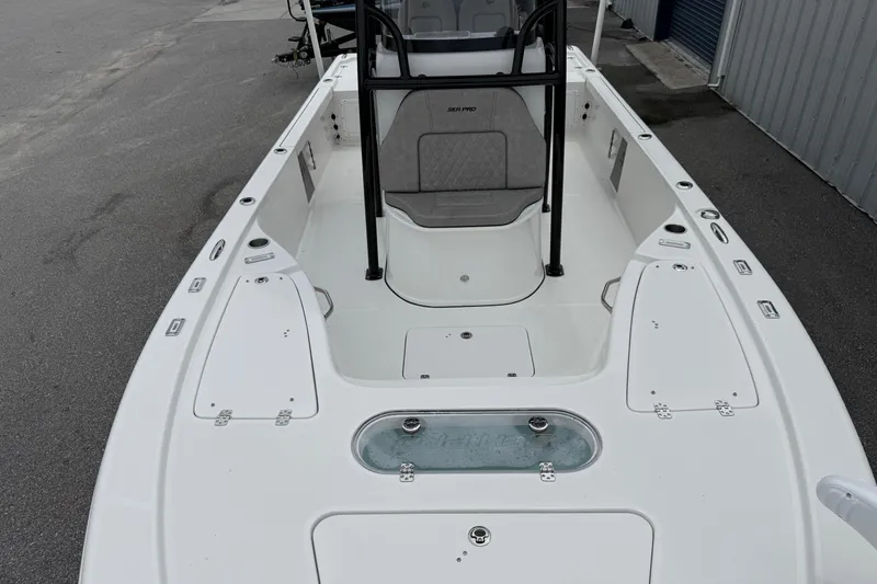 Slide: The Image of 2023 Sea Pro 248 Bay boat deck, featuring spacious seating and storage compartments. - 6
