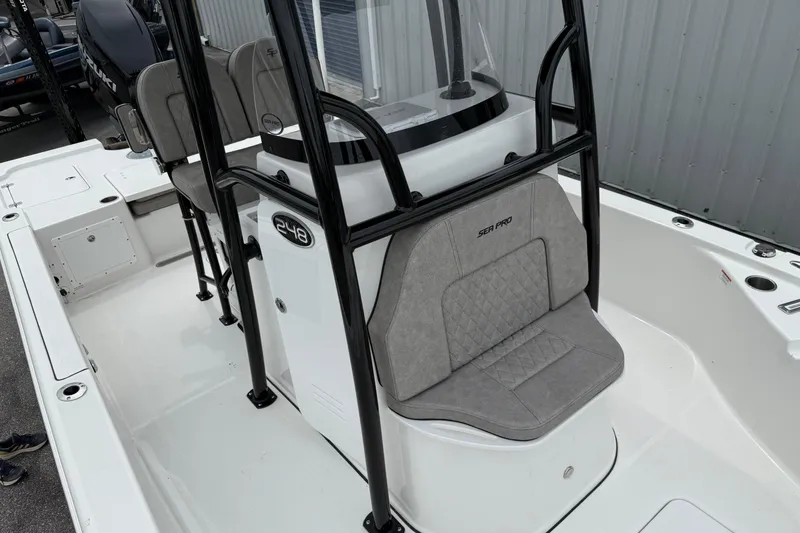 Slide: The Image of 2023 Sea Pro 248 Bay boat interior with seating and console design. - 9