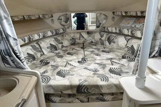 Slide: The Image of 2001 Wellcraft 330 Coastal cabin interior with patterned upholstery and compact design. - 10