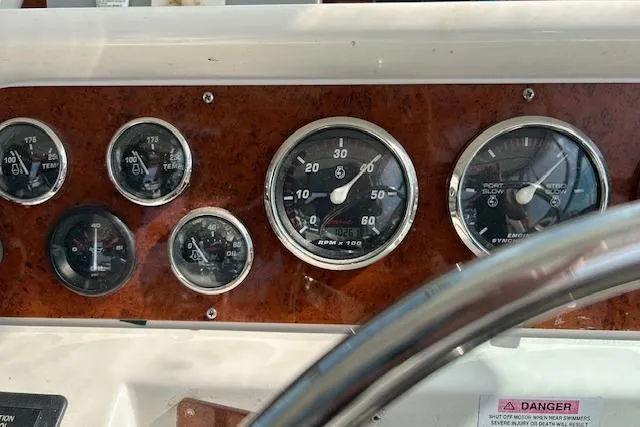 Slide: The Image of Dashboard of a 2001 Wellcraft 330 Coastal boat with various gauges and dials. - 12