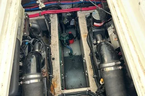 Slide: The Image of Engine compartment of a 2001 Wellcraft 330 Coastal boat, showing dual engines and wiring. - 6
