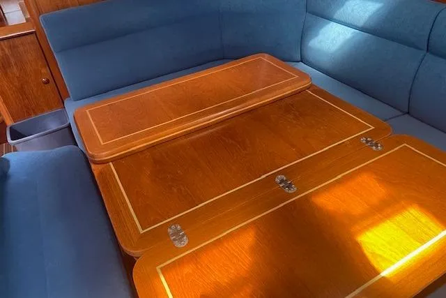 Slide: The Image of Interior of 2002 Jeanneau Sun Odyssey 45.2 yacht with wooden table and blue seating. - 13