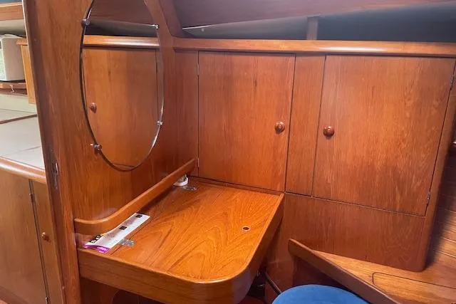 Slide: The Image of Interior of 2002 Jeanneau Sun Odyssey 45.2 yacht with wooden cabinetry and desk. - 16