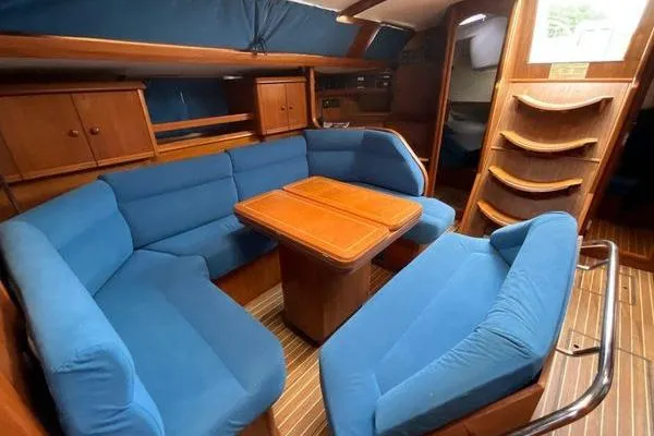 Slide: The Image of Interior of 2002 Jeanneau Sun Odyssey 45.2 yacht with blue seating and wooden table. - 18