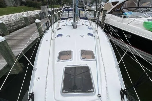 Slide: The Image of 2002 Jeanneau Sun Odyssey 45.2 sailboat docked, showcasing deck and rigging. - 2