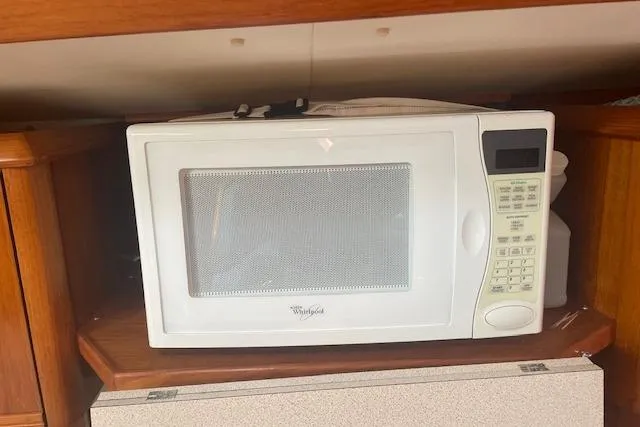Slide: The Image of White microwave in a 2002 Jeanneau Sun Odyssey 45.2 yacht kitchen. - 21