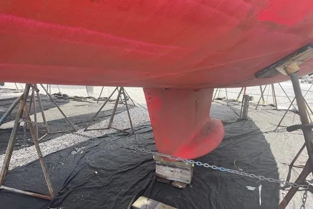 Slide: The Image of Red hull of 2002 Jeanneau Sun Odyssey 45.2 sailboat on stands. - 31