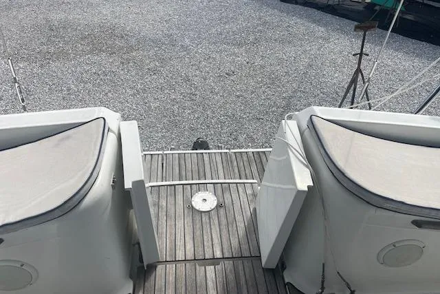 Slide: The Image of Jeanneau Sun Odyssey 45.2 yacht deck, 2002 model, featuring cushioned seating and wooden flooring. - 7