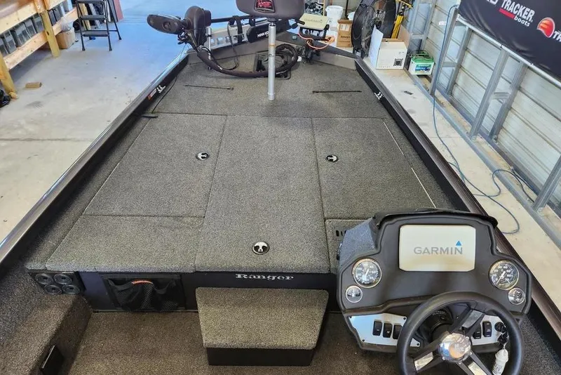 Slide: The Image of 2006 Sea Hunt Escape 200 boat with outboard motor in a garage setting. - 3