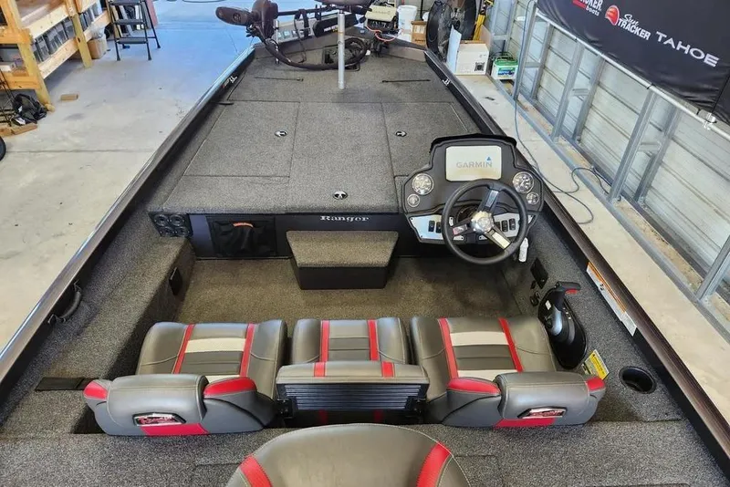 Slide: The Image of 2006 Sea Hunt Escape 200 boat interior with seating and steering console in a garage. - 4