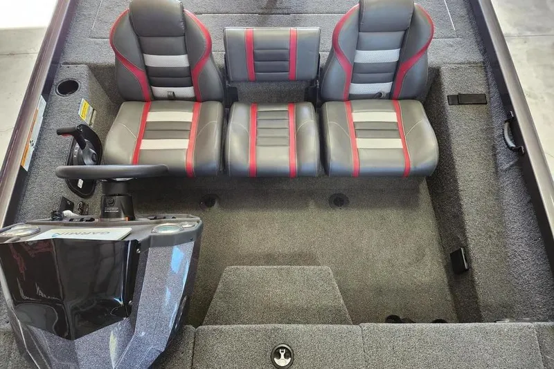 Slide: The Image of 2006 Sea Hunt Escape 200 boat interior with seating and canopy in a garage. - 6