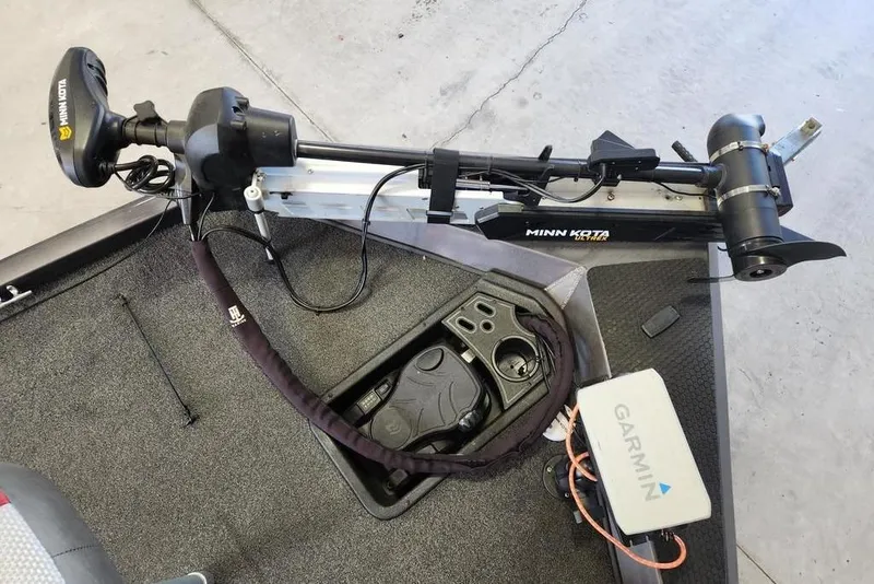 Slide: The Image of 2006 Sea Hunt Escape 200 boat interior with white seating in a garage setting. - 8