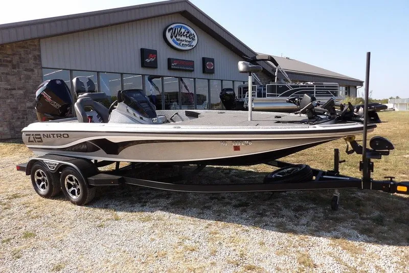 Slide: The Image of 2023 Nitro Z19 boat on trailer outside White's Marine Center. - 1