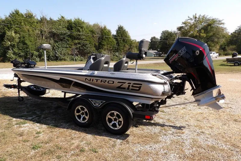 Slide: The Image of 2023 Nitro Z19 boat on trailer, parked outdoors, featuring sleek design and powerful engine. - 12